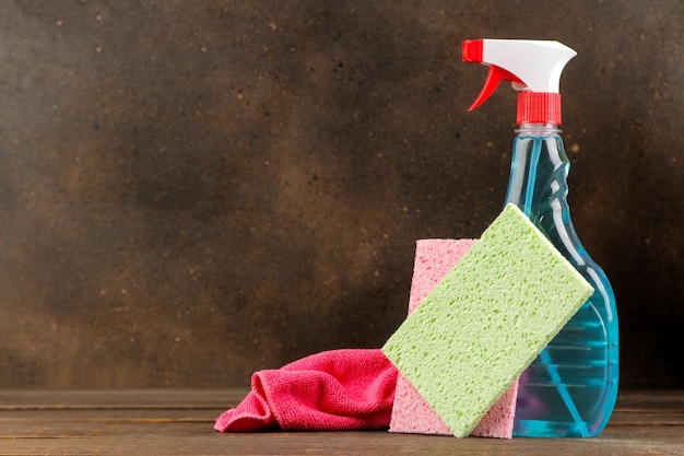 Bottles with cleansers and detergents on a brown background. cleaning. cleaning products. place for text. free space