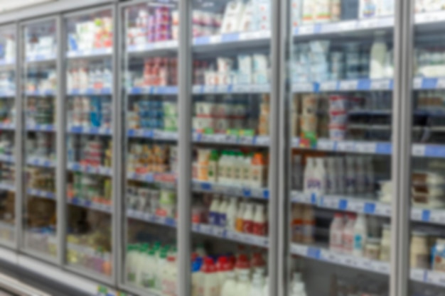 Bottles with milk on the shelves in the store Health and natural products Blurred Side view