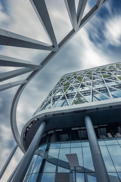 Bottom up view of contemporary office center building against sky with blurred clouds Moscow Russia