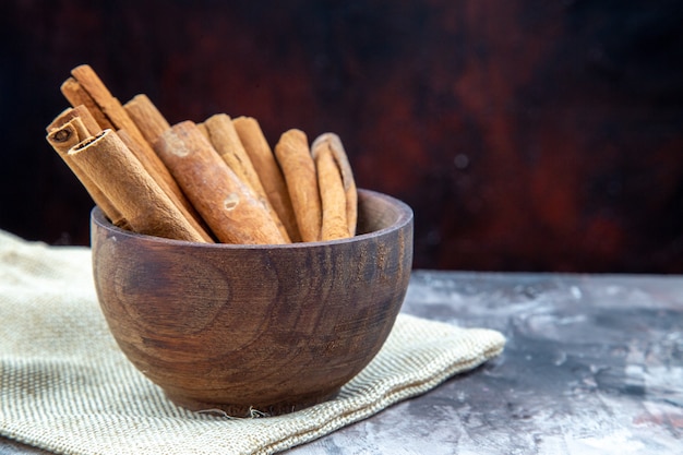 bottom view cinnamon sticks in wooden bowl on table