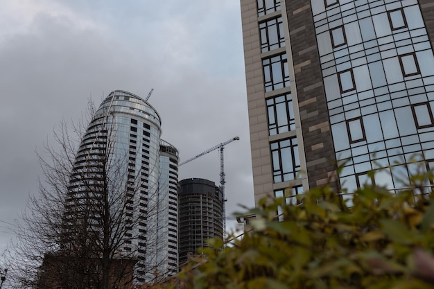 Bottom view of modern skyscrapers in business district against blue sky