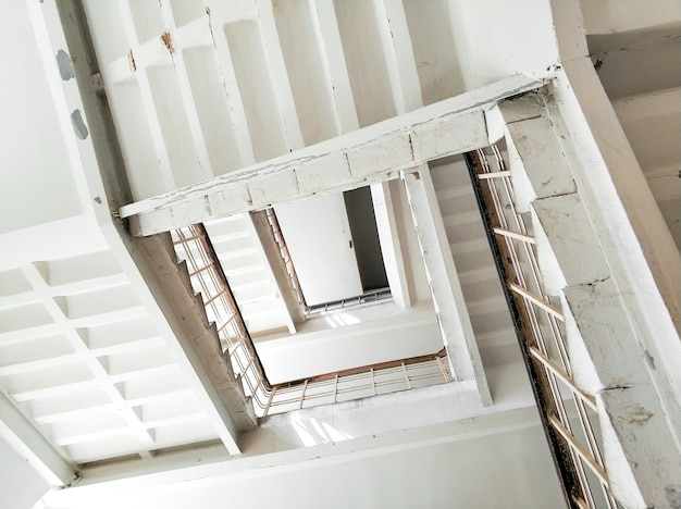 Bottom view of the stairwell of a tall building