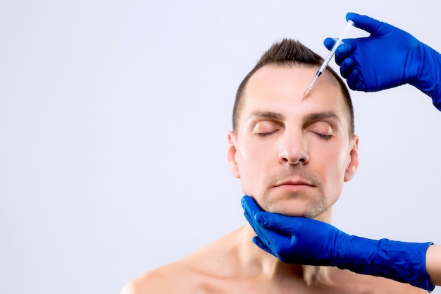 Botulinum Therapy. Close-up Of Person Hands Injecting Syringe With botox For Face Treatment. ESTHETOX. disport