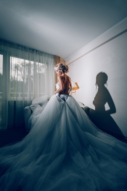 Boudoir of the bride. charming bride in the morning in a negligee prepares for the celebration