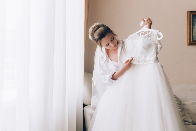 Boudoir of the bride. charming bride in the morning in a negligee prepares for the celebration