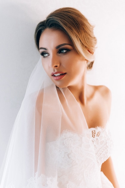 Boudoir of the bride. charming bride in the morning in a negligee prepares for the celebration