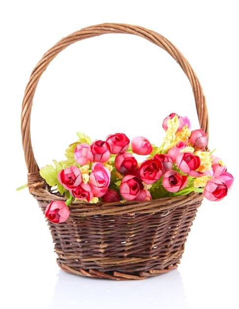 Bouquet of beautiful artificial flowers in wicker basket isolated on white