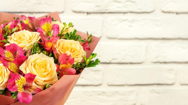 Bouquet of beautiful roses and alstroemeria on white background with copy space Floral shop concept