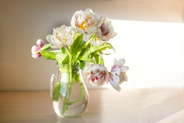 Bouquet of beautiful tulips Copy space International Womens Day celebration White wall background Scandinavian interior