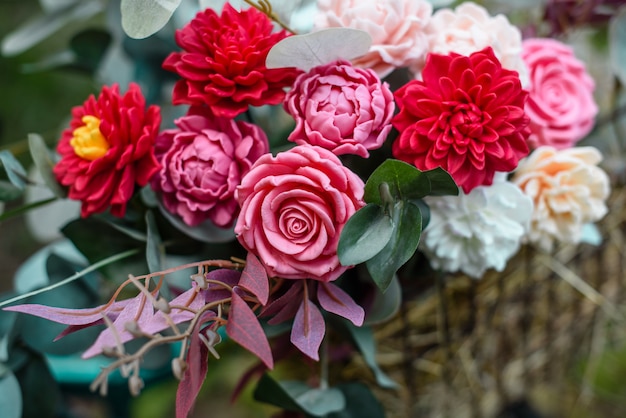 Bouquet of bright colourful colours made from soap in basket of old vintage bike in summer garden