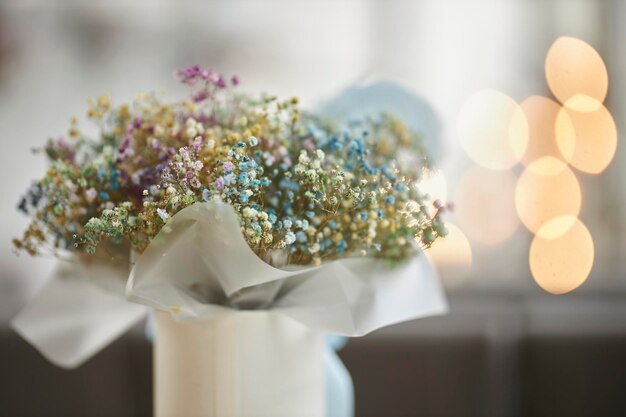 bouquet of dried flowers in a white box on a blurred background with bokeh