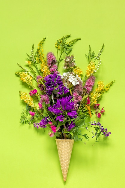 Bouquet field colored flowers in waffle ice cream cone