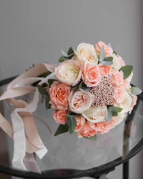 Bouquet of flowers for the bride on the wedding day Delicate ranunculus peony roses ozotamnus