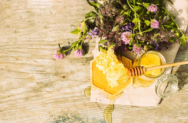 A bouquet of flowers and a honeycomb on a table