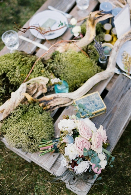 Bouquet of flowers lies on a served wedding table