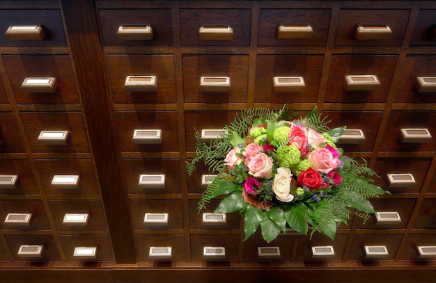 Bouquet of flowers near apothecary drawers