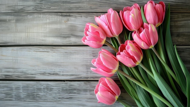 Bouquet of fresh beautiful delicate tulips on a wooden background as a gift photo in light pastel