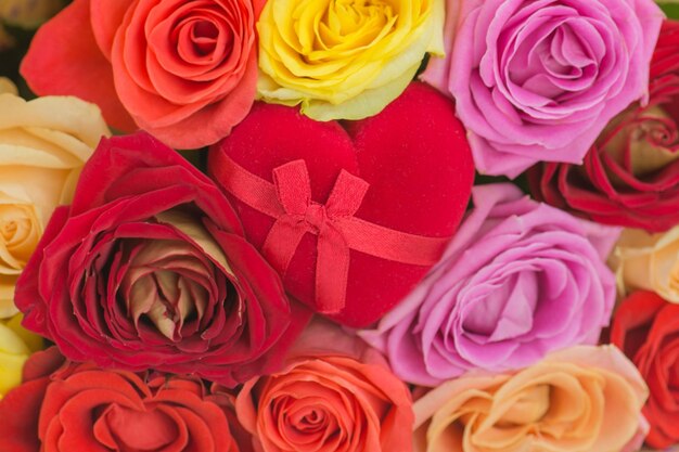 Bouquet of fresh beautiful flowers and ring in a heart shaped box Woman getting a marriage proposal