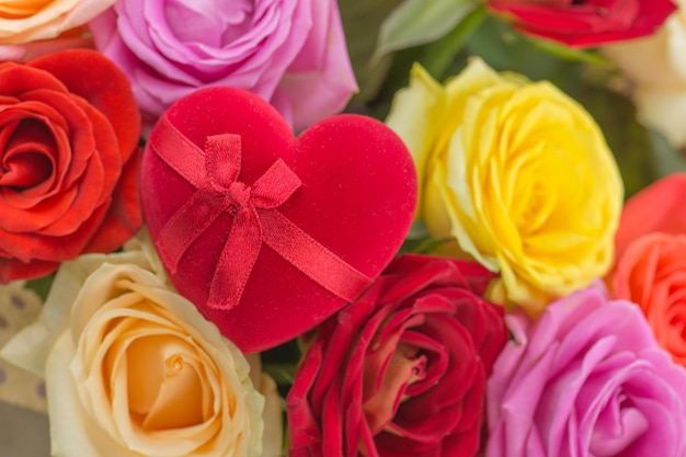 Bouquet of fresh beautiful flowers and ring in a heart shaped box