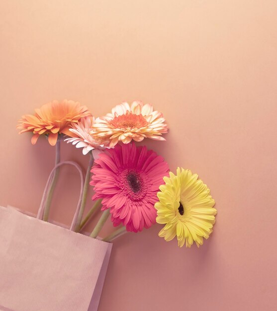 Bouquet of gerberas in a craft package background of powdery shades.