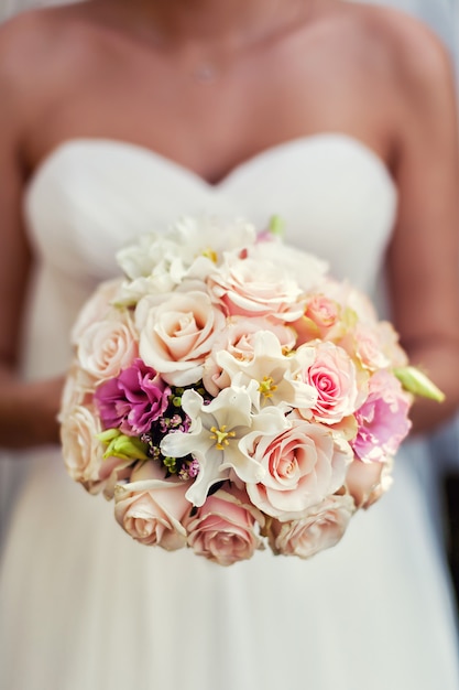 Bouquet in hands of the bride