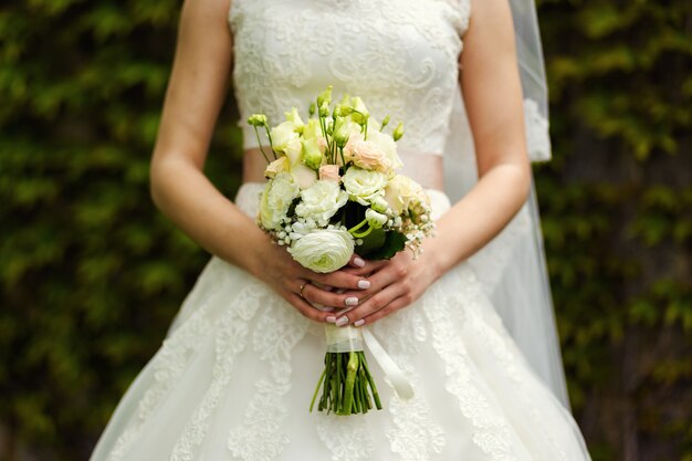 Bouquet in hands of the bride