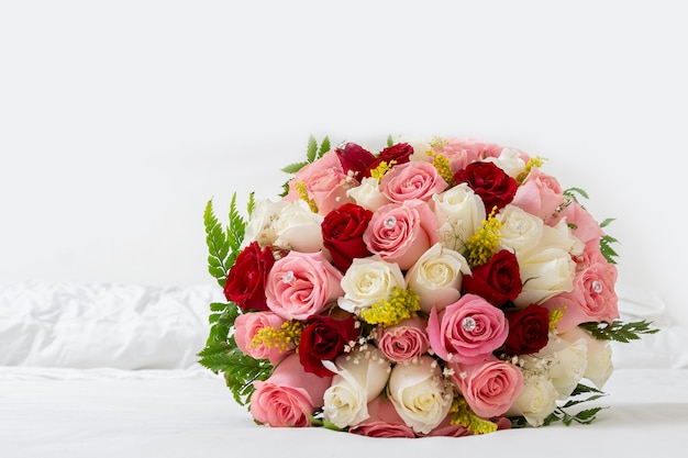 Bouquet of multicolored roses for a wedding on a white background