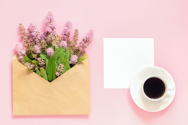 Bouquet of pink flowers in envelope