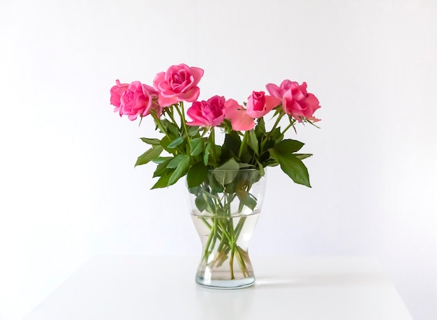 Bouquet of pink rose flowers in transparent vase Home decor