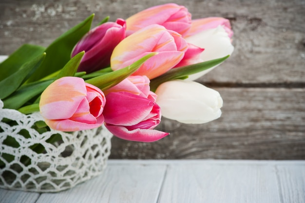 Bouquet of pink tulips in crochet basket