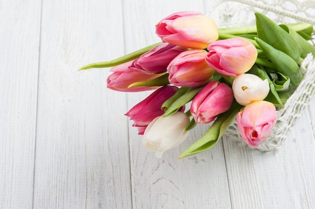 Bouquet of pink tulips in crochet basket