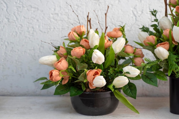 Bouquet of pink tulips in flower pot.Tulips and green herbs and leaves in floristic composition