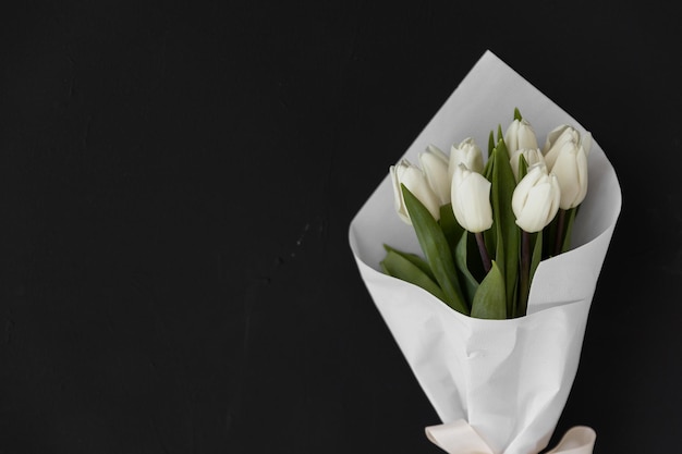 Bouquet of pink tulips on pink background Mothers day Valentines Day Birthday celebration concept Greeting card Copy space for text top view