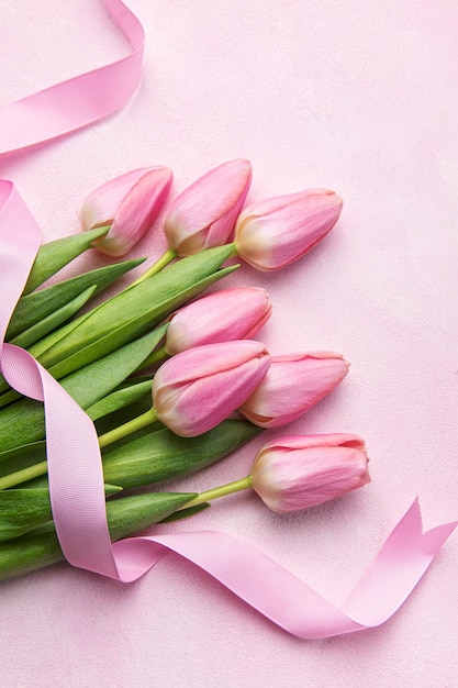 Bouquet of pink tulips on pink background