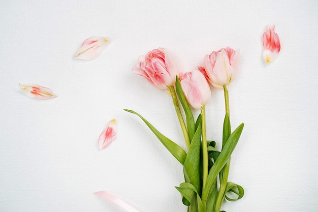 Bouquet of pink tulips. Top view, white background, text copy space.