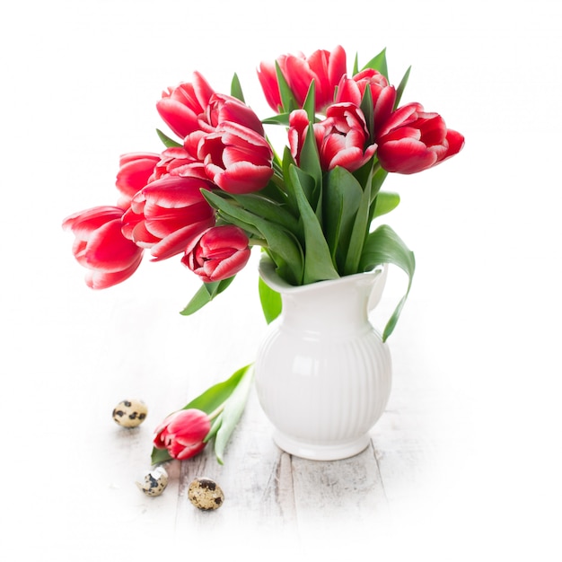 Bouquet of pink tulips in vase on the white background