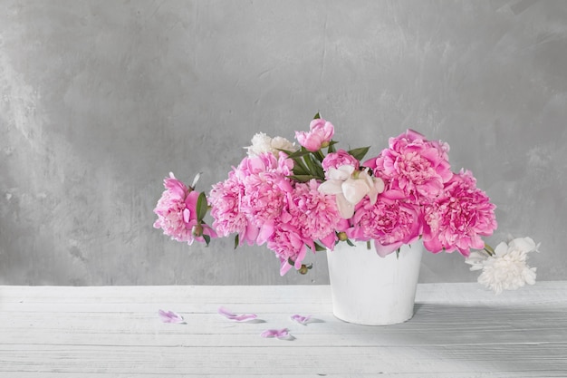 Bouquet of pink and white peonies  on background old wall