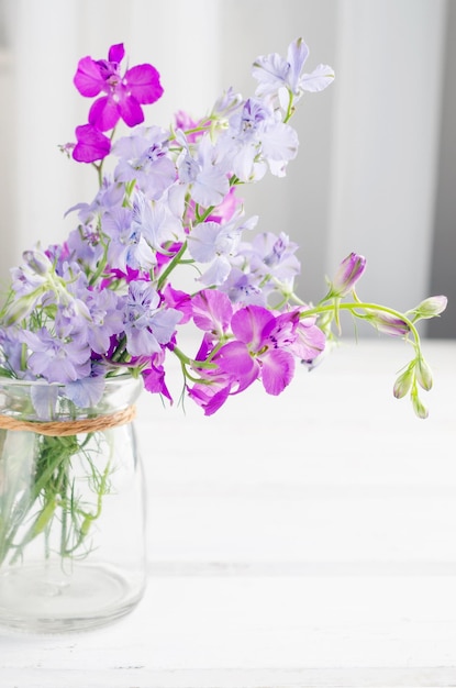 Bouquet of purple lupine flowers in a glass vase table