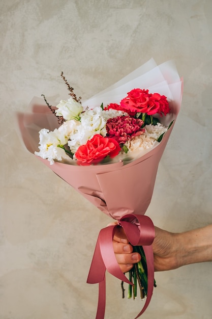 Bouquet of red roses, burgundy and white carnations, white eustomas