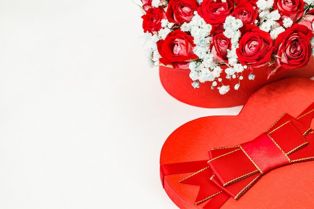 Bouquet of red roses in gift box in form of heart selective focus free space to copy text