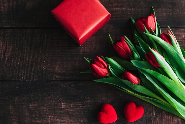 Bouquet of red tulips on a wooden background.