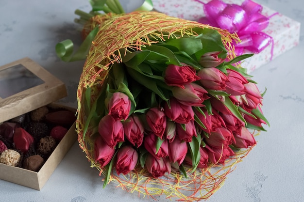 Bouquet of roses, box of chocolates and gift for Valentine