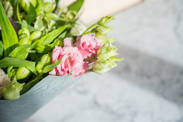 Bouquet of roses daisies lisianthus chrysanthemums unopened buds on blurred background present mothe