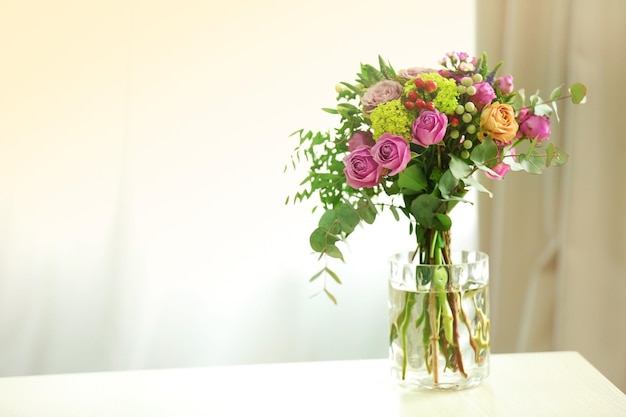 Bouquet of roses in jar on the table