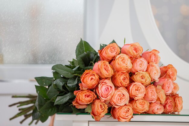 A bouquet of roses lies on the pillowsGift for the holiday Bouquet of roses