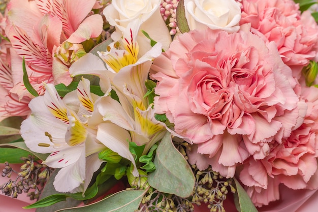 Bouquet of soft pink flowers in pink wrapping paper