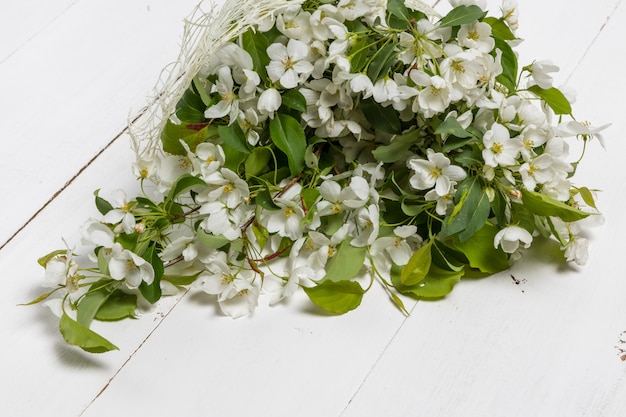 Bouquet of spring apple tree flowers in a vase. Romantic floral still life