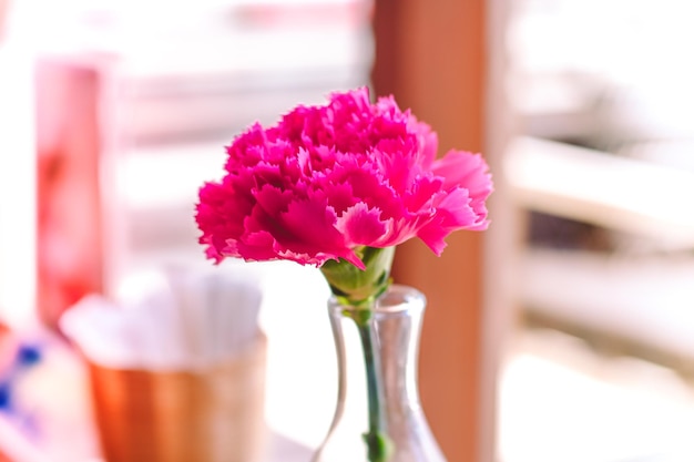 A bouquet of spring flowers in a vase in a glass bottle