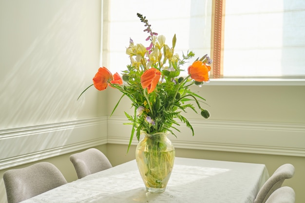 Bouquet of spring summer flowers and red poppies in vase