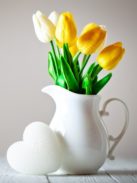 Bouquet of spring tulips on a bright wall